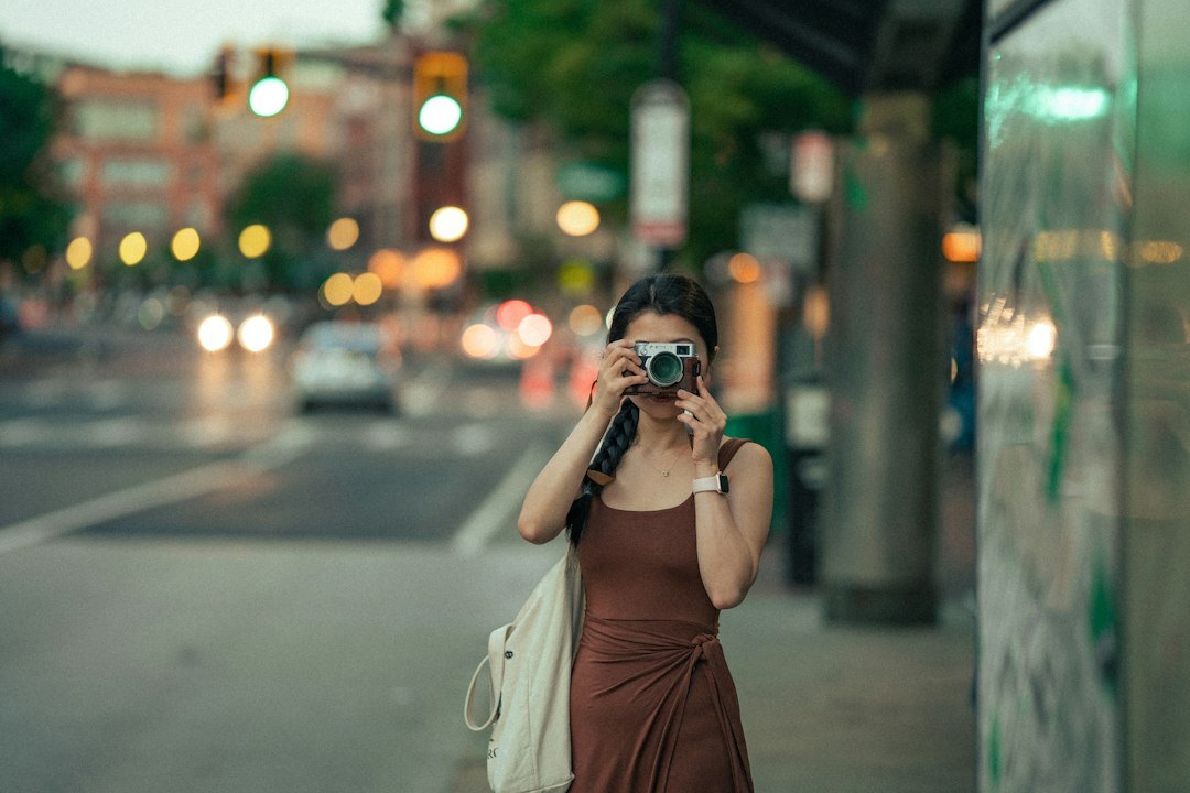 Female photographer holding a camera on the street